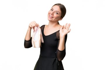 Young beautiful blonde woman practicing ballet over isolated background saluting with hand with happy expression