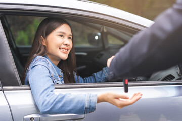 Business car rental, sell or buy service, dealership hand of agent dealer, sale man giving auto key of vehicle to customer renter, buyer young woman receiving, client or tenant, transfer automobile.