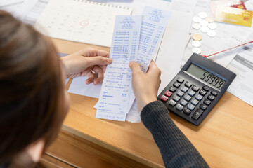 Stress asian young employee, businesswoman hand holding bills and calculate budget, cost income,...
