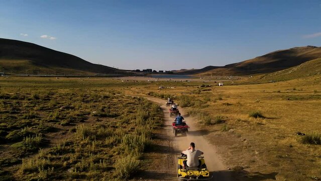 Aerial View From Behind ATVs by Lake and Mountain