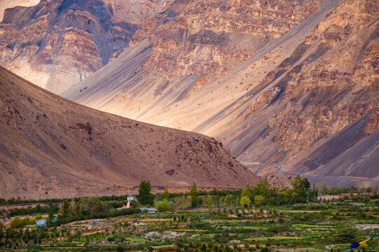 A scenic view of the green fields and ancient monastery in the Himalayan village of Tabo in the Spiti Valley in Himachal Pradesh, India.
