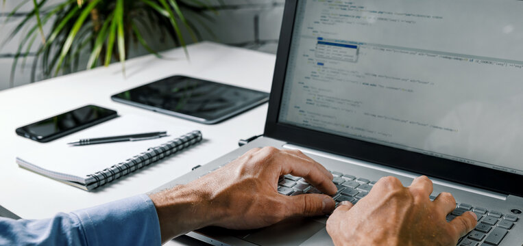 coder web developer write code on laptop computer. website programming, software development