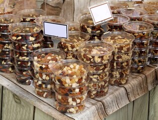 Fototapeta na wymiar Energy snacks with nuts and dried fruits in plastic containers on the store shelf