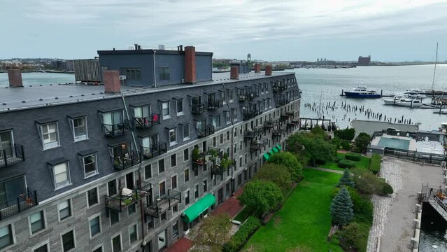 Exclusive upscale apartment condo living by waterfront. American city life by dock. Residential living. Aerial view.