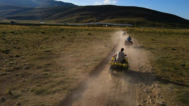 Aerial View From Behind ATVs by Lake and Mountain