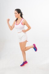 Naklejka premium Studio portrait photo of a young beautiful elegant Brazilian female model lady wearing sports exercise running attire posing with a series moments of emotion and gesture 