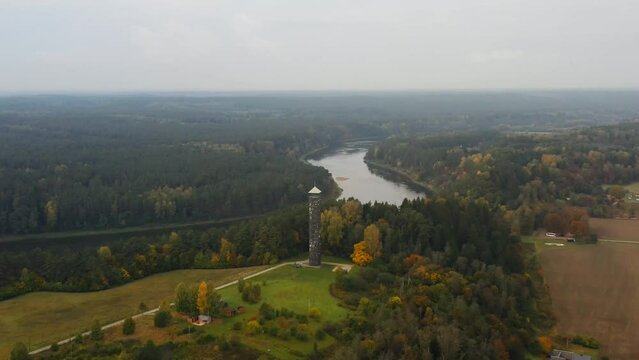 Birstonas tower is one of the most visited atractions in Lithuania, drone footage flying around in circle with autumn color woods and river Nemunas can be seen