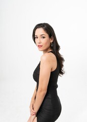Studio portrait photo of a young beautiful elegant Brazilian female model lady wearing a black dining dress posing with a series moments of emotion and gesture 