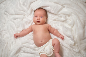 Portrait of a newborn baby lying on a soft, fluffy surface