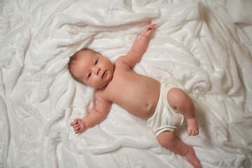 Portrait of a newborn baby lying on a soft, fluffy surface