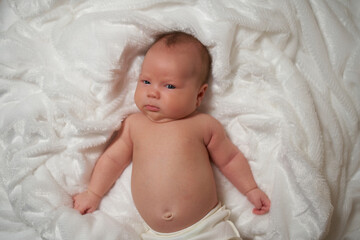 Portrait of a newborn baby lying on a soft, fluffy surface