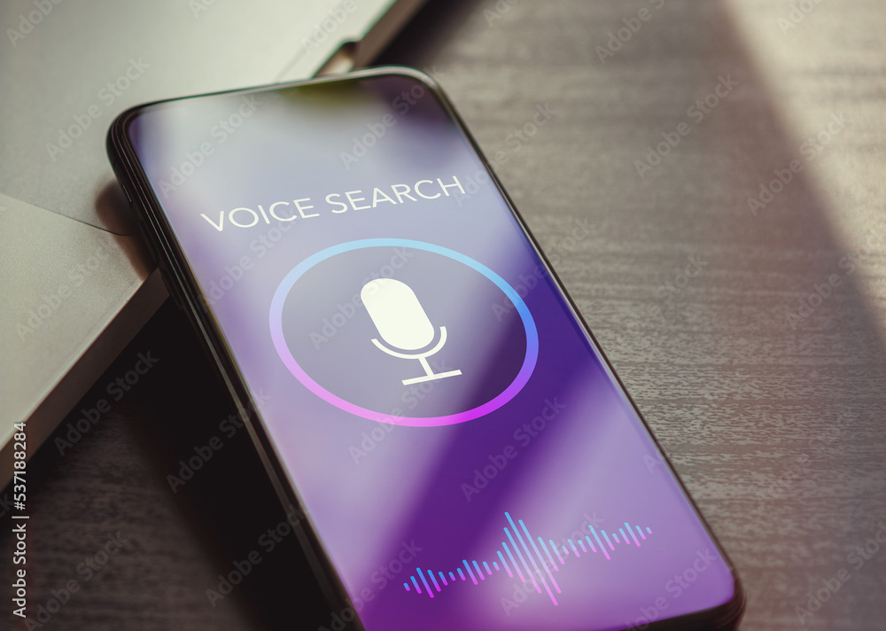 Poster voice search, speech recognition and sound detect app concept with close up smartphone lying on a bl