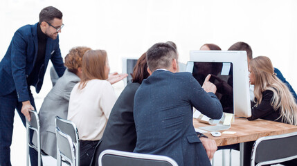 through the glass. working group discussing something in the office