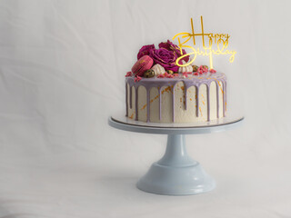 macaron rose meringue berries and gold paint decorated frosted birthday cake