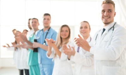 group of diverse medical staff members applauding together