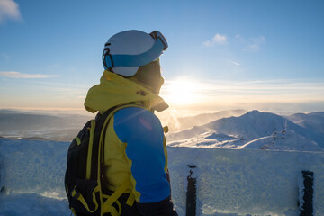 woman skier looking at sunset above slovakia mountains
