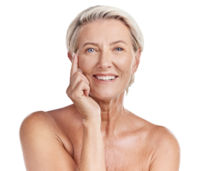Portrait of a happy smiling mature caucasian woman looking positive and cheerful while posing topless in a studio against purple copyspace background. Older woman doing her skincare routine