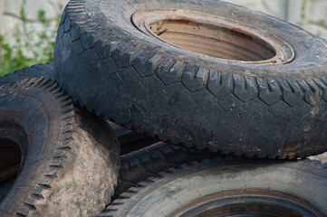 Landfill with old tires and tyres for recycling. Reuse of the waste rubber tyres. Disposal of waste tires. Worn out wheels for recycling. Tyre dump burning plant. Regenerated tire rubber produced