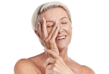One happy mature caucasian woman relaxing with a hand on her face against a pink background. Smiling senior woman resting, caring for her skin while doing a skincare routine