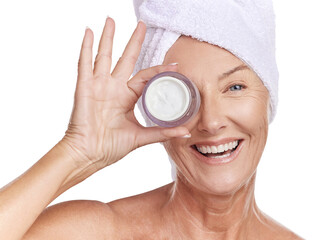 Portrait of a happy smiling caucasian woman using moisturiser against purple copyspace background. Mature model doing her routine skin and hair care in a studio