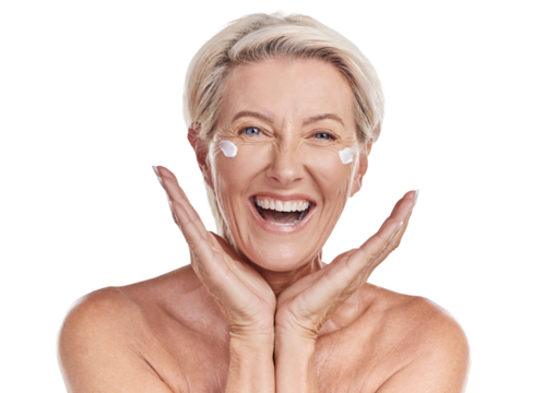 Portrait of one happy mature caucasian woman posing topless against a purple copyspace background. Ageing woman applying cream, moisturiser, sunblock during a skincare routine in a studio