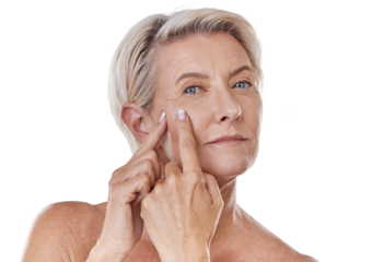 Portrait of one mature caucasian woman popping a zit during a skin care routine while posing against a grey copyspace background. Older model with a pimple targeting acne in a studio