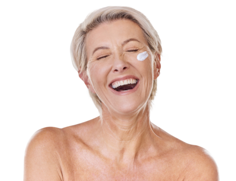 One smiling happy mature caucasian woman posing topless against a purple copyspace background. Ageing woman applying cream, moisturiser, sunblock during a skincare routine in a studio - Powered by Adobe