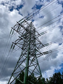 High voltage electrical network with cloudy sky.