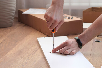 A man collects new furniture at home