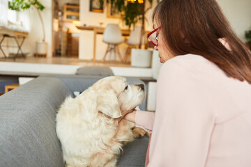 Senior woman with her pet retriever dog