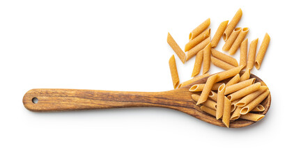 Uncooked whole grain pasta isolated on white background. Raw penne pasta on spoon.