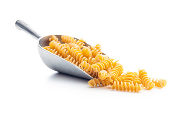 Uncooked whole grain pasta isolated on white background. Raw pasta in scoop.