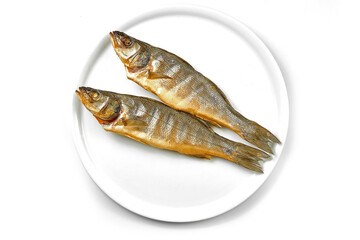 Smoked sea fish in a white plate on a white background. Close-up, selective focus.