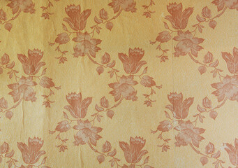 Old wallpaper on the wall. Old wallpaper for texture or background.