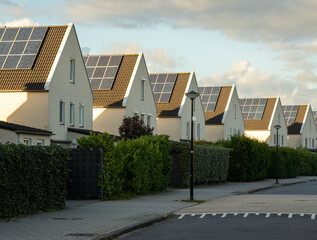 Modern houses in a row with solar panels on the roof in largest photovoltaic neighbourhood of The Netherlands in Heerhugowaard