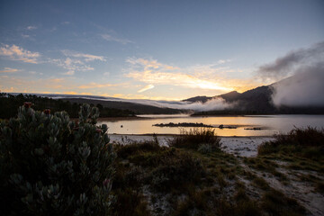 sunset over a lake in the mountains