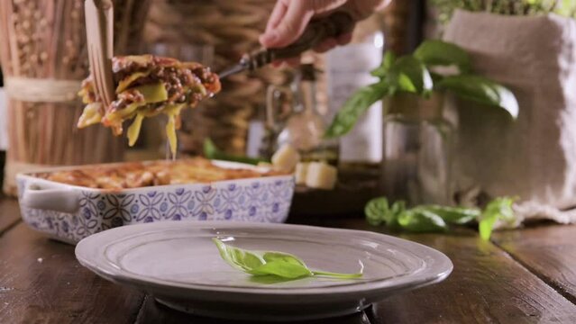 Lasagna with pesto.Italian lunch,homemade green lasagna with spinach in the dough, ragu - meat sauce, bechamel and parmesan cheese. illage dining atmosphere in Italy. 