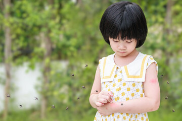 Little girl has skin rash allergy itching and scratching on her arm with mosquitoes bite