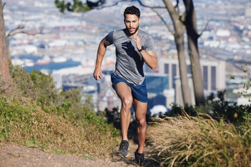 City, runner and man running in nature training, cardio exercise and endurance workout for a...