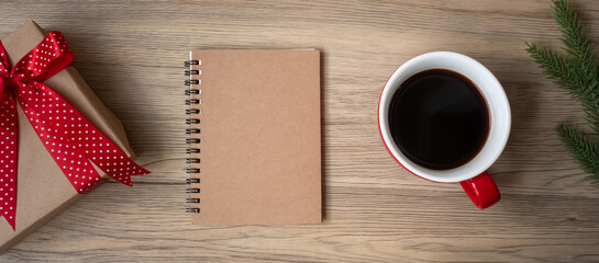 Blank notebook, black coffee cup and Christmas gift on wood table, Top view and copy space. Xmas, Happy New Year, Goals, Resolution, To do list, Strategy and Plan concept
