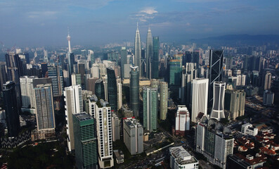 Kuala Lumpur, Malaysia, aerial drone city view. Financial business district skyscrapers are seen in the background.