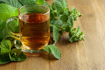 Mint tea on a wooden table.