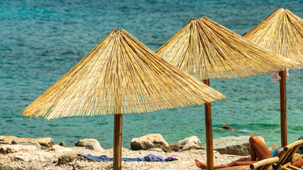 Parasol on a beach by the sea in beautiful vacation weather