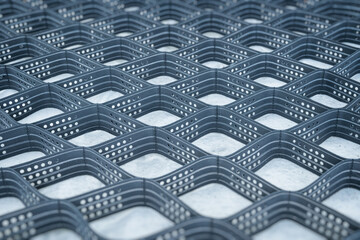 Polymeric geogrid for slope reinforcement. Grid of cells for filling with soil or stones.