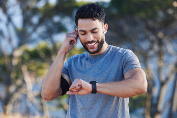 Man, runner and smartwatch outdoor for workout listening to music, radio or streaming on web....