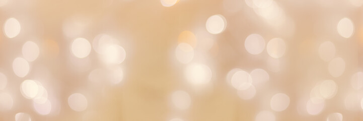 Defocused abstract bokeh background beige pastel colored, flare from lights, beige monochrome...