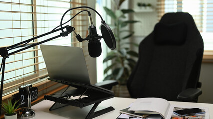 Home studio with laptop and condenser microphone. Entertainment, podcasts and technology concept