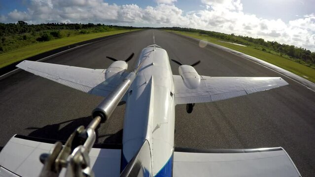 Twin Engine Aircraft accelerates down runway and takes off. Camera mounted to tail.