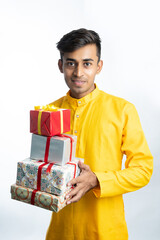 Man holding gift boxes during Diwali festival