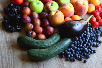 Round straw bag and various healthy fruits and vegetables on wooden background. Selective focus.